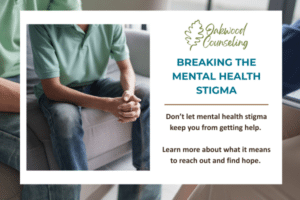 Man sitting on therapist's couch with hands clasped, overcoming mental health stigma.